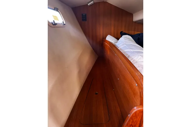 Slide: The Image of Interior cabin of 2007 Hunter 38 sailboat with wooden paneling and bedding. - 43