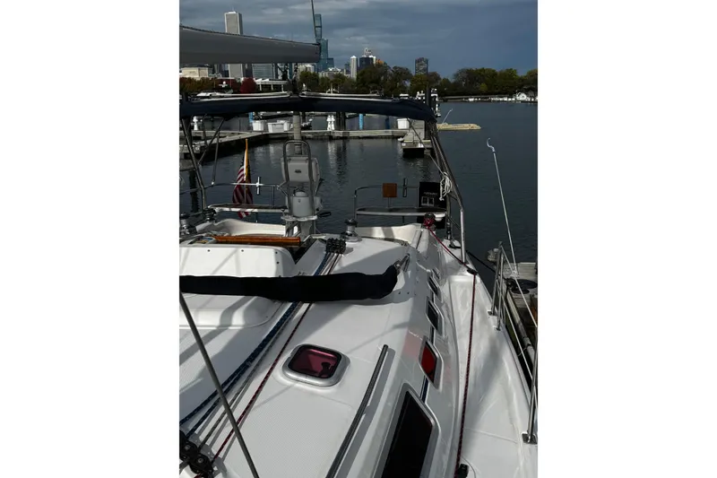 Slide: The Image of Sailboat docked in marina, Hunter 38 model, 2007, with city skyline in background. - 5