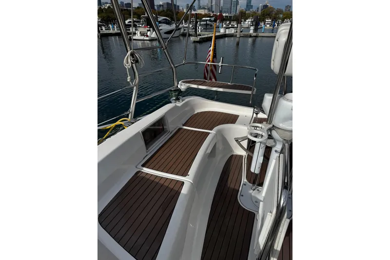Slide: The Image of 2007 Hunter 38 sailboat cockpit with wooden deck, docked in marina. - 6