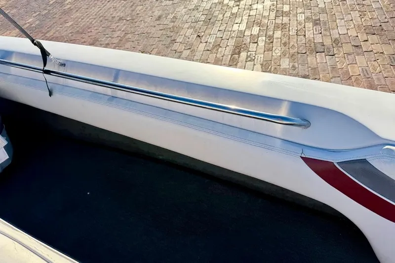 Slide: The Image of Interior view of a 1993 Nautique Sport Nautique 200 boat, showing seating and railing. - 12