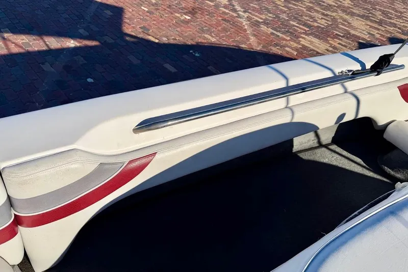 Slide: The Image of 1993 Nautique Sport Nautique 200 interior with white and red upholstery, chrome rail. - 13