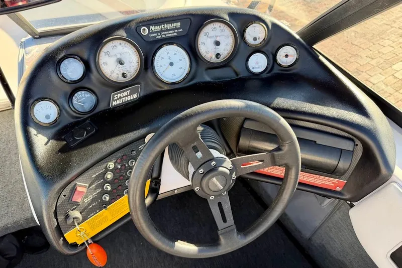 Slide: The Image of 1993 Nautique Sport Nautique 200 dashboard with gauges and steering wheel. - 18