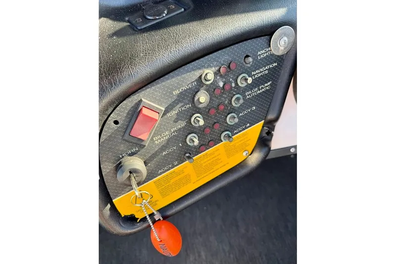 Slide: The Image of 1993 Nautique Sport Nautique 200 dashboard with ignition and control switches. - 20
