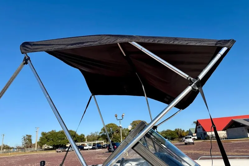 Slide: The Image of 1993 Nautique Sport Nautique 200 with bimini top under clear blue sky. - 7