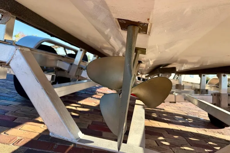 Slide: The Image of Propeller and trailer of 1993 Nautique Sport Nautique 200 boat on brick surface. - 8