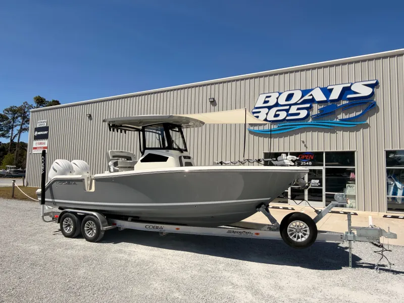 The Image of 2026 Cobia 245CC boat on trailer outside Boats365 store. - 0