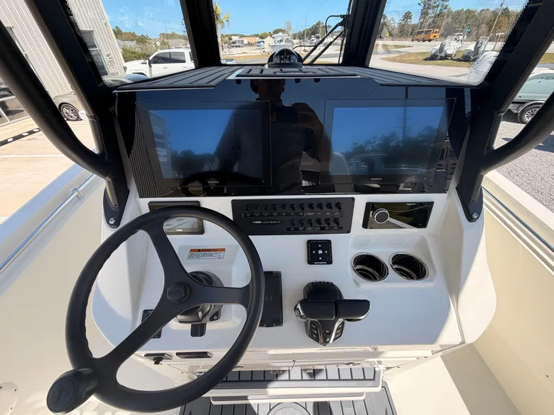 Slide: The Image of Cobia 245CC 2026 helm with modern displays and controls. - 13