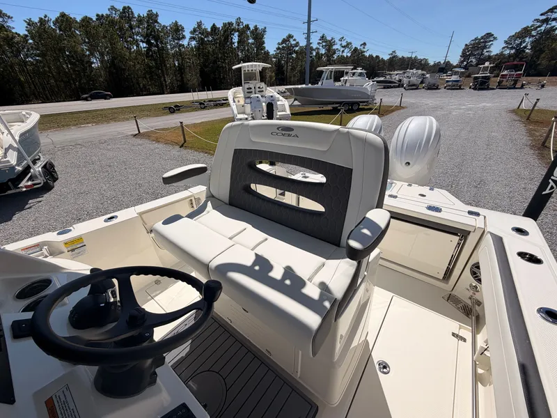 Slide: The Image of 2026 Cobia 245CC boat with helm and seating area. - 16
