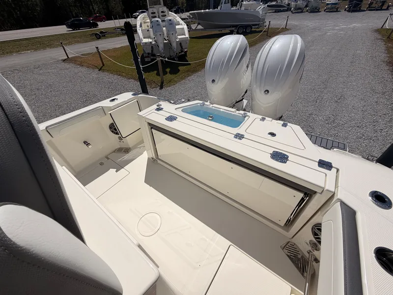 Slide: The Image of 2026 Cobia 245CC boat with dual engines and spacious deck. - 19