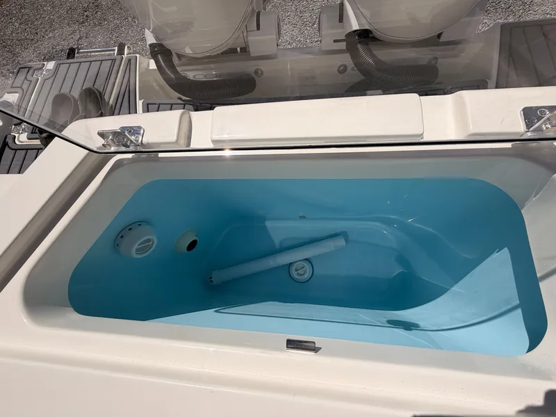 Slide: The Image of Cobia 245CC 2026 boat with open storage compartment. - 20