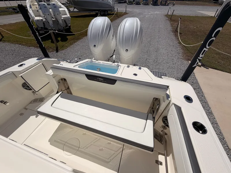 Slide: The Image of 2026 Cobia 245CC boat interior with dual engines. - 21
