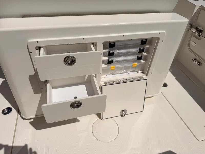 Slide: The Image of Cobia 245CC 2026 boat with storage compartments and drawers. - 22