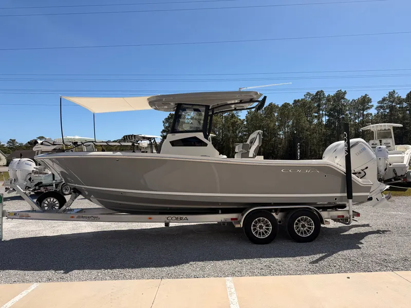Slide: The Image of 2026 Cobia 245CC boat on trailer, side view. - 5