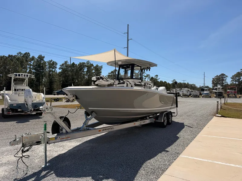 Slide: The Image of 2026 Cobia 245CC boat on trailer parked outdoors. - 6
