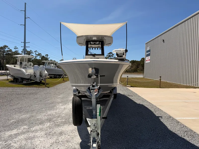 Slide: The Image of 2026 Cobia 245CC boat on trailer outside warehouse. - 7