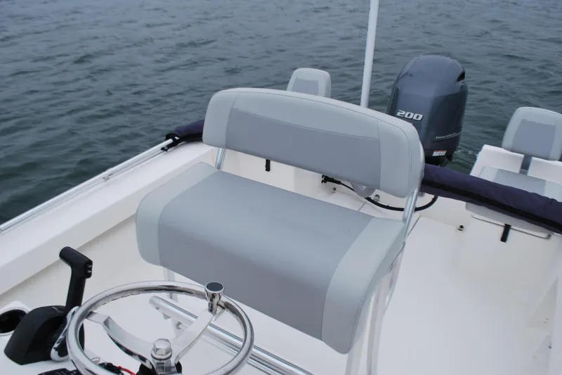 Slide: The Image of 2023 Bay Rider 239 Bay boat interior with steering wheel and motor. - 17
