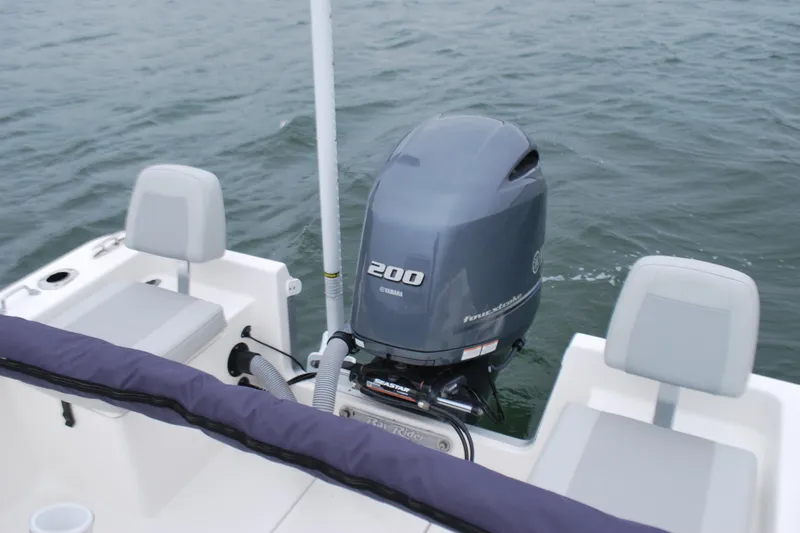 Slide: The Image of 2023 Bay Rider 239 Bay boat with Yamaha 200 outboard motor on water. - 21