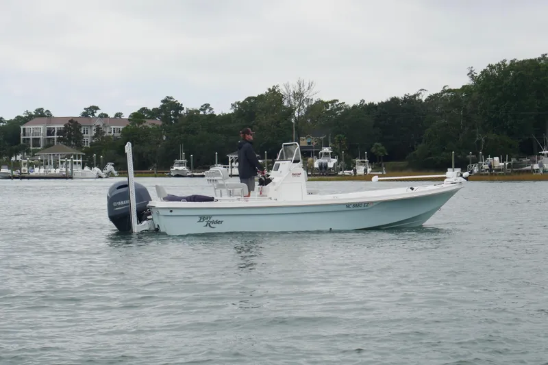 Slide: The Image of 2023 Bay Rider 239 Bay boat on water, with Yamaha motor, near marina. - 5