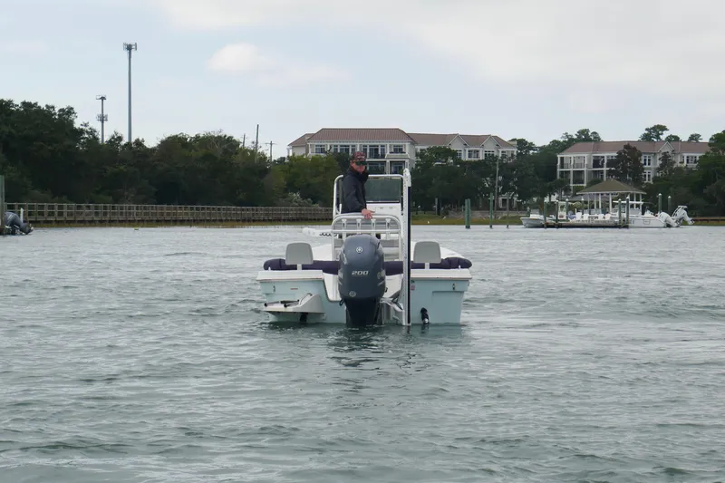 Slide: The Image of 2023 Bay Rider 239 Bay boat on water near residential area. - 7
