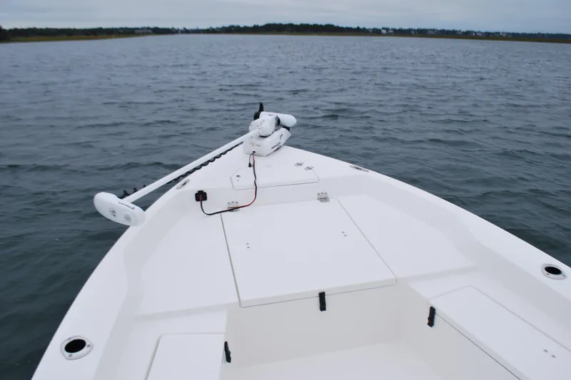 Slide: The Image of 2023 Bay Rider 239 Bay boat on open water, featuring a sleek white deck design. - 9