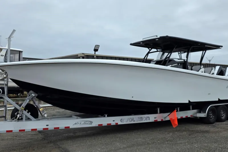 Slide: The Image of 2026 Nor-Tech 390 Sport Center Console boat on trailer, ready for adventure. - 1
