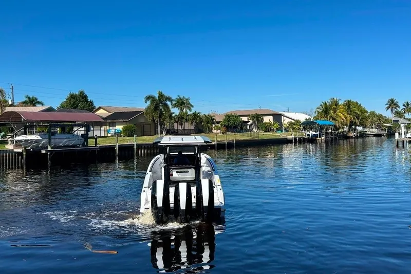 Slide: The Image of 2026 Nor-Tech 390 Sport Center Console cruising on a sunny canal. - 17