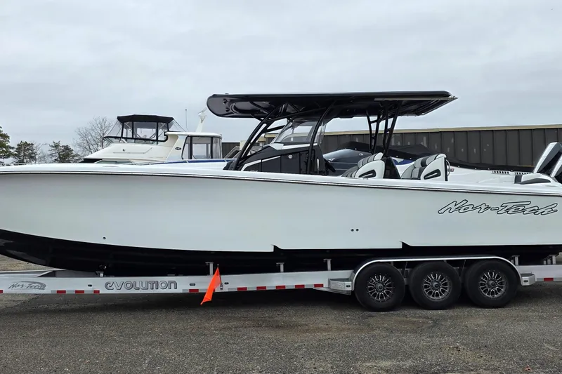 Slide: The Image of 2026 Nor-Tech 390 Sport Center Console boat on a trailer, side view. - 30