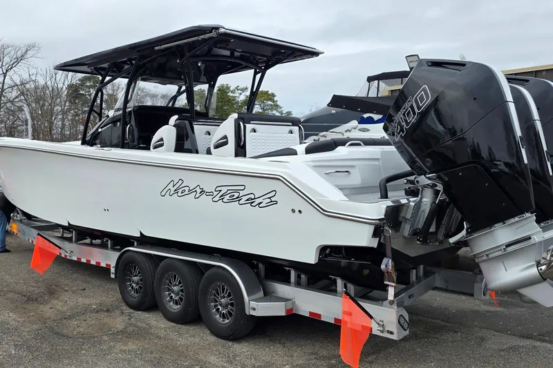 Slide: The Image of 2026 Nor-Tech 390 Sport Center Console boat on trailer with powerful outboard engines. - 7