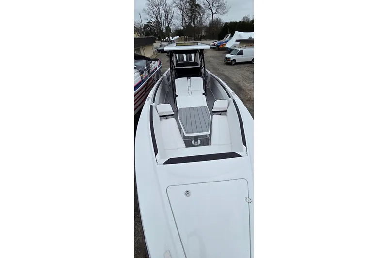 Slide: The Image of 2026 Nor-Tech 390 Sport Center Console boat, sleek design, spacious seating, outdoor setting. - 8