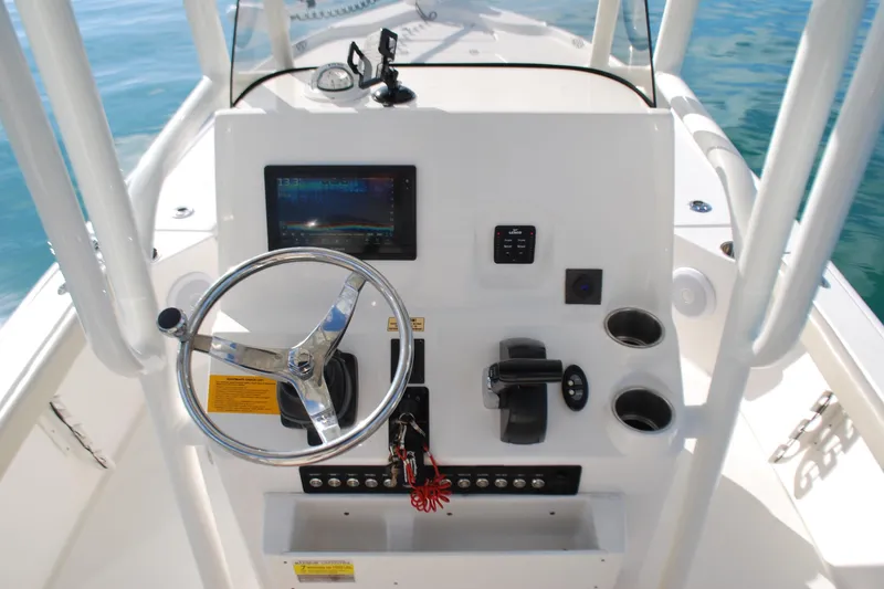 Slide: The Image of 2021 Key West 210 Bay Reef boat console with steering wheel and controls. - 10