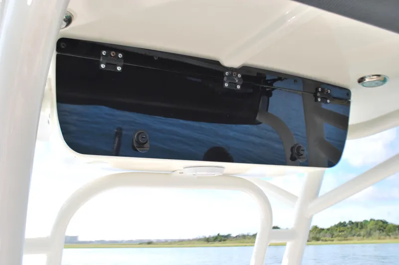 Slide: The Image of 2021 Key West 210 Bay Reef boat console with black panel and scenic water view. - 11