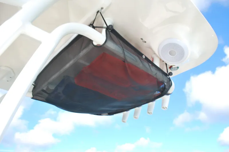 Slide: The Image of 2021 Key West 210 Bay Reef boat with overhead storage net and speaker system. - 12