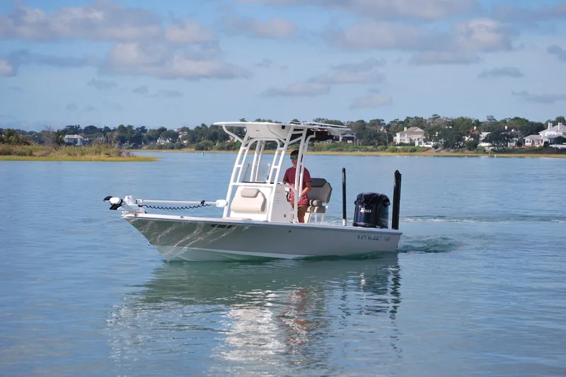 Slide: The Image of 2021 Key West 210 Bay Reef boat cruising on calm water, scenic background. - 3