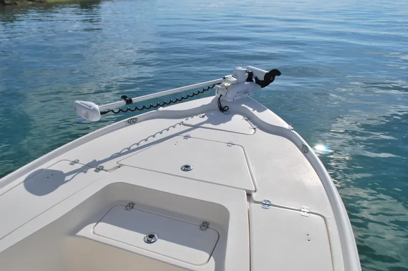 Slide: The Image of 2021 Key West 210 Bay Reef boat on calm water, featuring a trolling motor. - 5