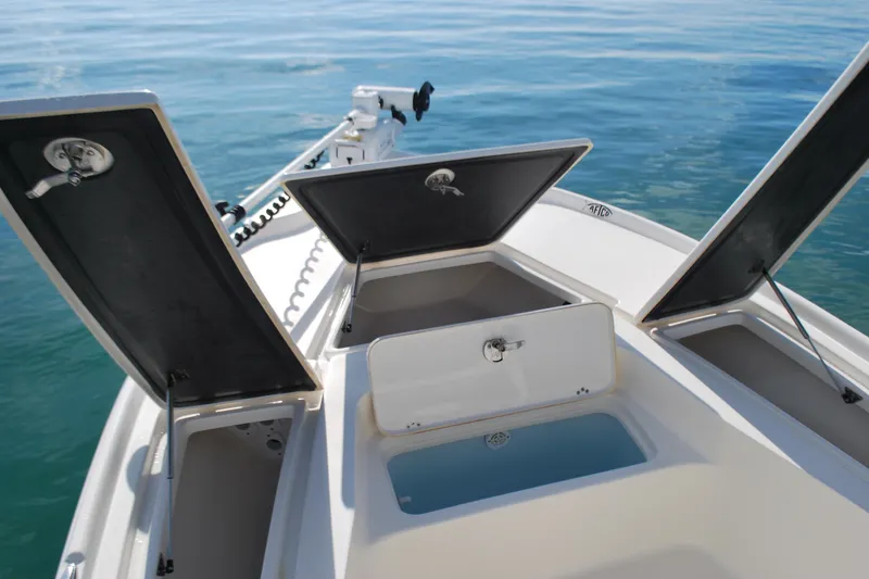 Slide: The Image of 2021 Key West 210 Bay Reef boat with open storage compartments on calm water. - 8