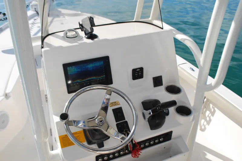 Slide: The Image of 2021 Key West 210 Bay Reef boat console with steering wheel and navigation display. - 9