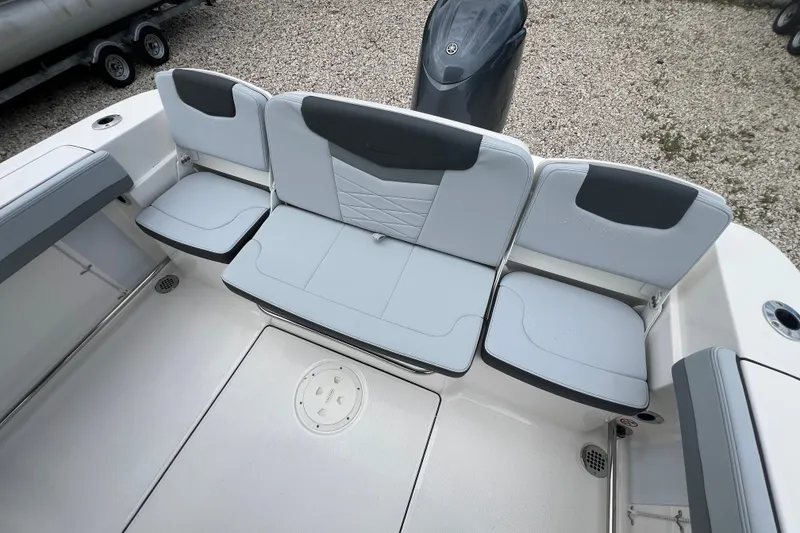 Slide: The Image of 2026 Robalo R207 Dual Console boat seating area with modern design and comfortable cushions. - 10