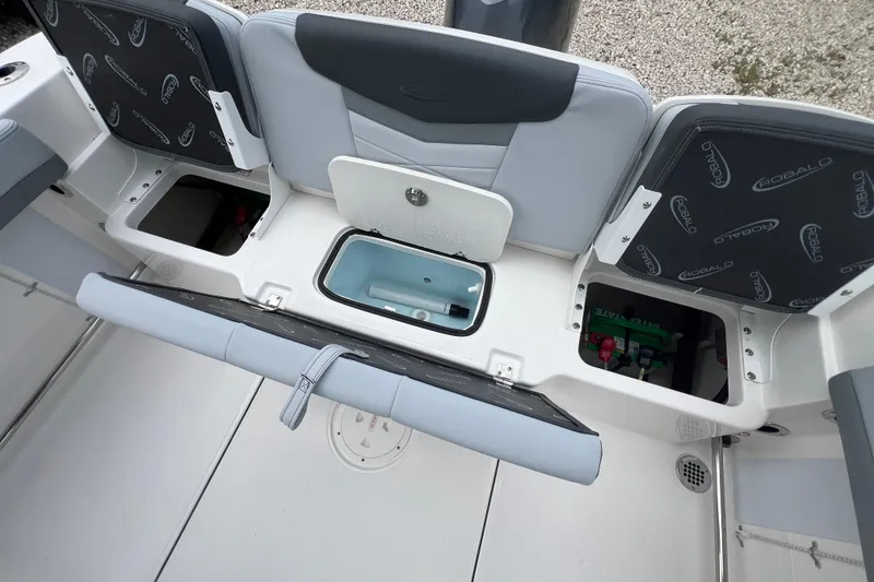 Slide: The Image of 2026 Robalo R207 Dual Console boat interior with storage compartments open. - 11