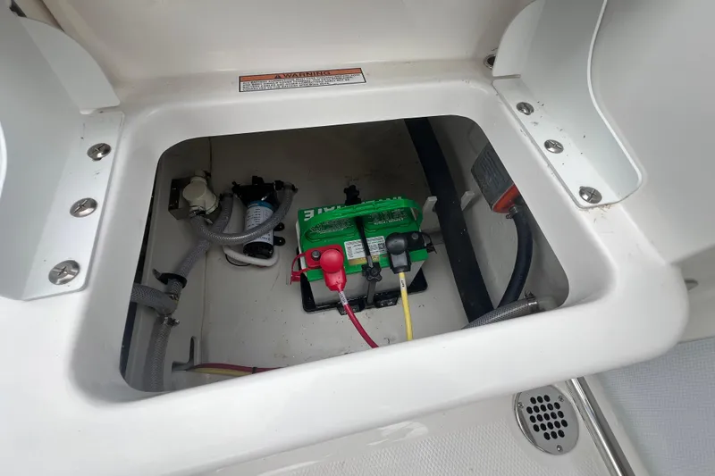 Slide: The Image of Battery compartment of 2026 Robalo R207 Dual Console boat, showing wiring and components. - 12