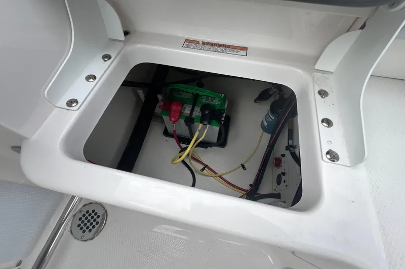 Slide: The Image of Battery compartment of 2026 Robalo R207 Dual Console boat, showing wiring and connections. - 14