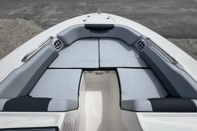 Slide: The Image of 2026 Robalo R207 Dual Console boat interior with cushioned seating and speakers. - 18