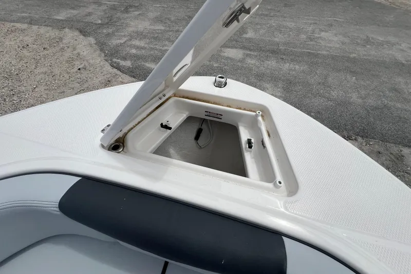 Slide: The Image of Open storage compartment on 2026 Robalo R207 Dual Console boat deck. - 19