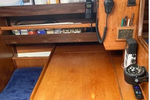 Slide: The Image of Interior of 1983 Wauquiez 38 sailboat with navigation equipment and wooden desk. - 11