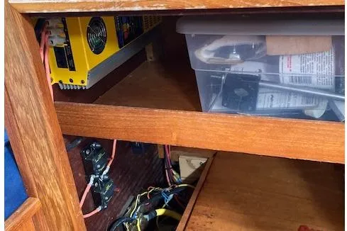 Slide: The Image of Interior view of a 1983 Wauquiez 38 sailboat showing electrical components and storage. - 12