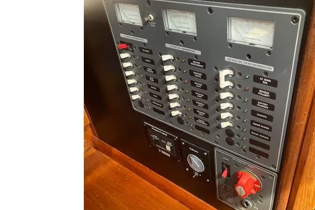 Slide: The Image of Electrical panel of a 1983 Wauquiez 38 sailboat with switches and gauges. - 13