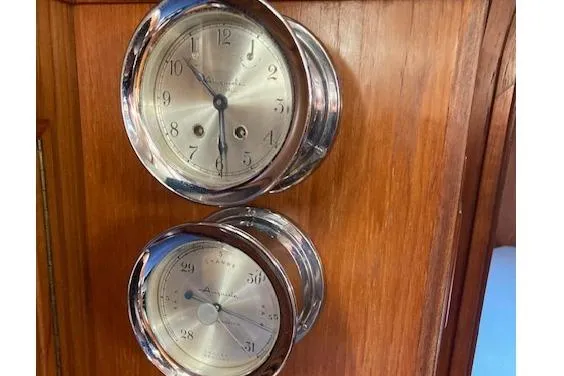 Slide: The Image of Vintage nautical clock and barometer on 1983 Wauquiez 38 yacht's wooden interior. - 16