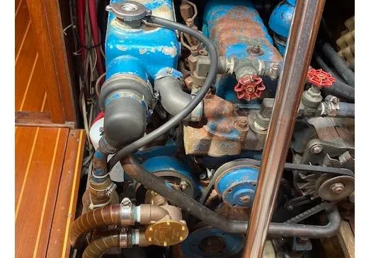 Slide: The Image of Engine compartment of a 1983 Wauquiez 38 sailboat, featuring blue mechanical components. - 17