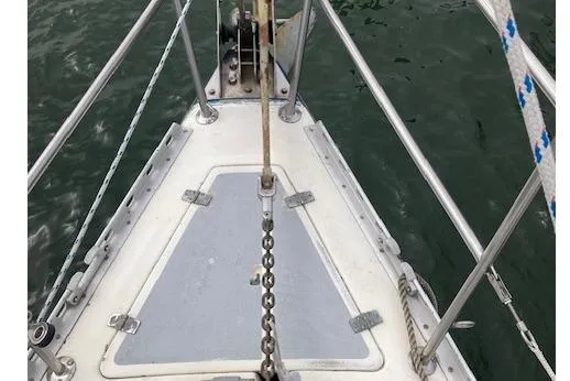 Slide: The Image of Bow of 1983 Wauquiez 38 sailboat with anchor chain and railing. - 2