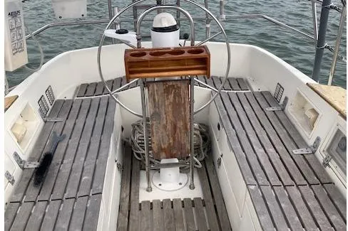 Slide: The Image of Cockpit of 1983 Wauquiez 38 sailboat with wooden seating and steering wheel. - 3