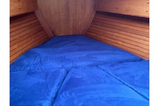 Slide: The Image of Cozy cabin interior of 1983 Wauquiez 38 sailboat with blue bedding. - 6